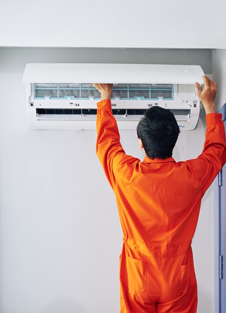 Un technicien Logista Hometech entretient une climatisation réversible