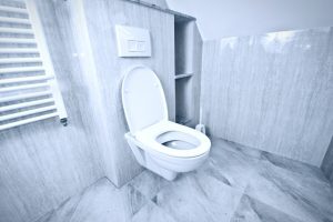 Des toilettes bouchées dans une salle de bain blanche